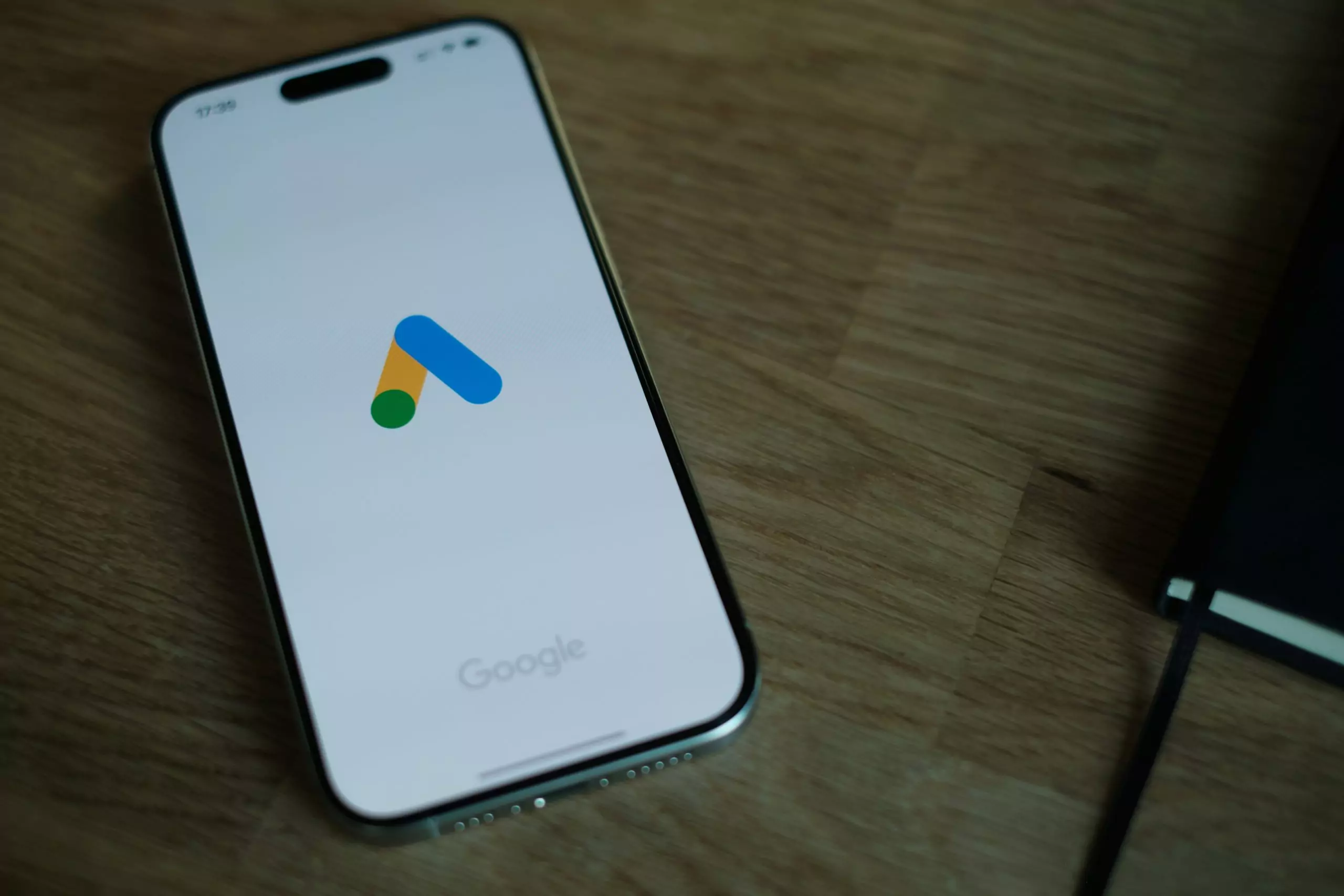 a phone on a table with a google ads logo
